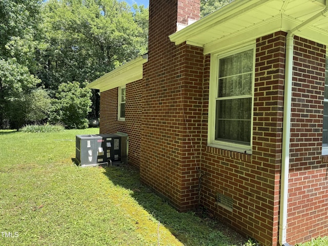 414/360 Woodsdale Rd, Roxboro, NC 27574 - view of home's exterior featuring brick siding, a yard, and a chimney