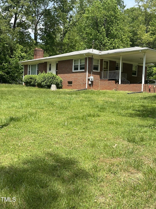 414/360 Woodsdale Rd, Roxboro, NC 27574 - view of front of property featuring brick siding, a chimney, an attached carport, and a front lawn