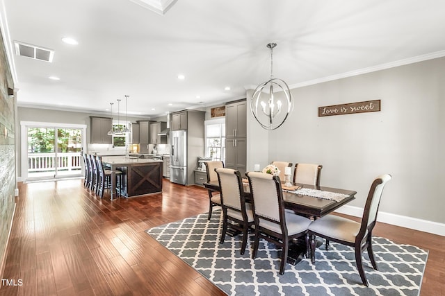 2218 Watersglen Dr, Apex, NC 27502 - dining area featuring ornamental molding, a chandelier, recessed lighting, and dark wood-style floors