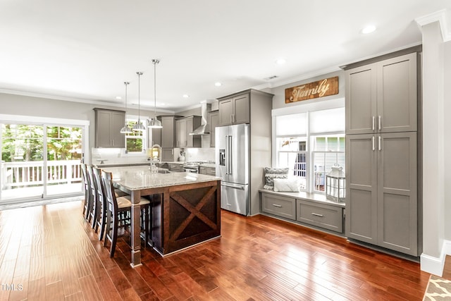 2218 Watersglen Dr, Apex, NC 27502 - kitchen featuring stainless steel appliances, gray cabinetry, crown molding, light stone countertops, and an island with sink