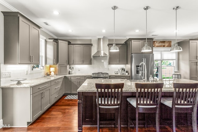 2218 Watersglen Dr, Apex, NC 27502 - kitchen with gray cabinetry, wall chimney range hood, stainless steel appliances, ornamental molding, and decorative backsplash