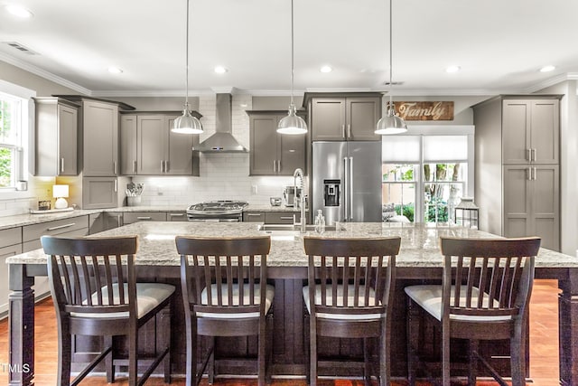 2218 Watersglen Dr, Apex, NC 27502 - kitchen featuring appliances with stainless steel finishes, wall chimney exhaust hood, gray cabinets, a large island, and decorative backsplash