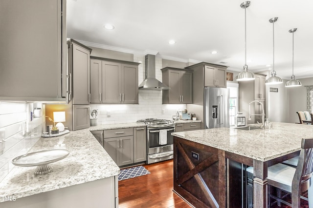 2218 Watersglen Dr, Apex, NC 27502 - kitchen featuring stainless steel appliances, wall chimney range hood, ornamental molding, gray cabinets, and decorative backsplash