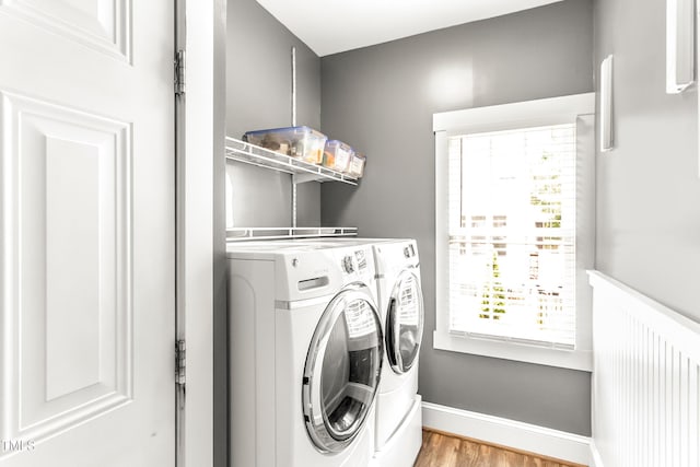 2218 Watersglen Dr, Apex, NC 27502 - washroom featuring washing machine and clothes dryer and light wood-style flooring