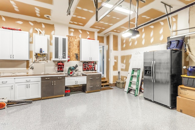 2218 Watersglen Dr, Apex, NC 27502 - kitchen featuring stainless steel refrigerator with ice dispenser, tankless water heater, white cabinets, and light countertops