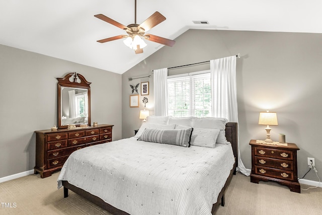 2218 Watersglen Dr, Apex, NC 27502 - bedroom featuring light carpet, multiple windows, vaulted ceiling, and ceiling fan