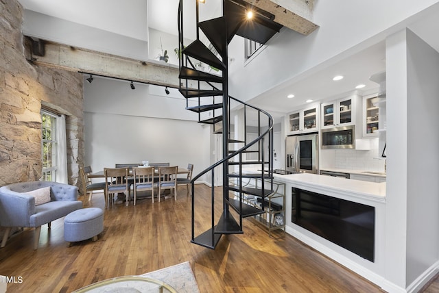 1500 River Mill Dr Unit 310, Wake Forest, NC 27587 - living room with a towering ceiling, stairs, and wood finished floors