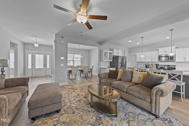 1013 Sagamore Dr, Louisburg, NC 27549 - living area featuring light wood-type flooring, recessed lighting, a ceiling fan, and a chandelier