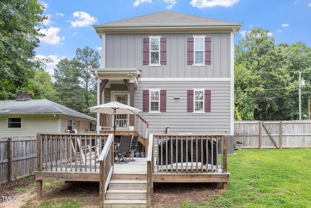 1304 Castlebay Rd, Durham, NC 27703 - rear view of property featuring a fenced backyard, a wooden deck, and board and batten siding