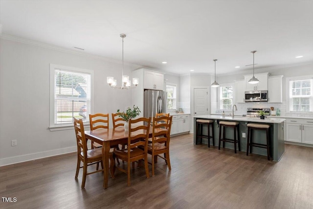 1304 Castlebay Rd, Durham, NC 27703 - dining space with dark wood-style flooring, crown molding, a chandelier, and recessed lighting