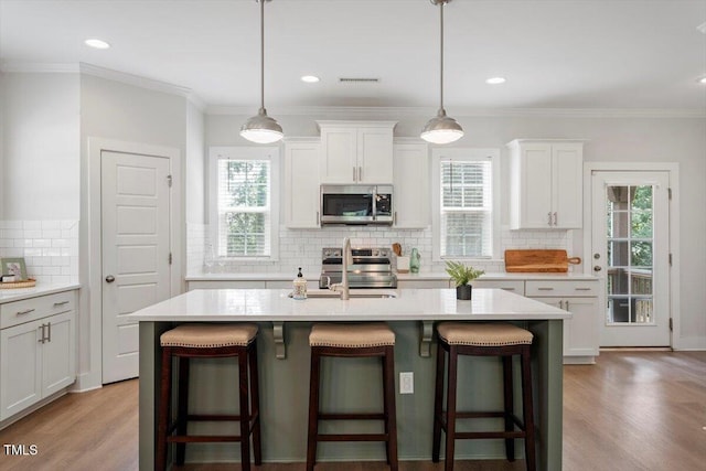 1304 Castlebay Rd, Durham, NC 27703 - kitchen with stainless steel appliances, backsplash, light countertops, crown molding, and recessed lighting