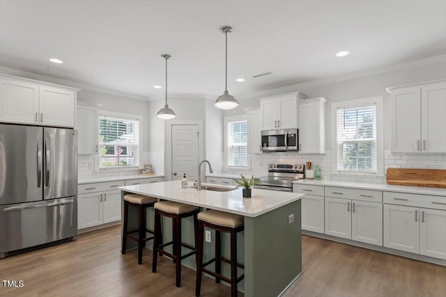 1304 Castlebay Rd, Durham, NC 27703 - kitchen featuring stainless steel appliances, backsplash, plenty of natural light, light countertops, and crown molding