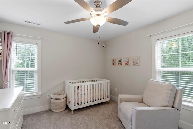 1304 Castlebay Rd, Durham, NC 27703 - bedroom with multiple windows, light colored carpet, and a nursery area