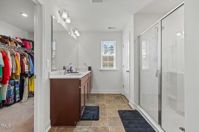 120 Misty Grove Trl, Franklinton, NC 27525 - full bathroom with vanity, a shower stall, a spacious closet, and stone finish floors