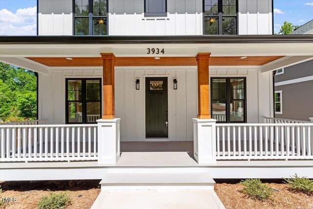 3934 Old Chapel Hill Rd, Durham, NC 27707 - view of exterior entry featuring covered porch and board and batten siding