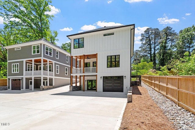 3934 Old Chapel Hill Rd, Durham, NC 27707 - rear view of house with a balcony, concrete driveway, a ceiling fan, an attached garage, and board and batten siding