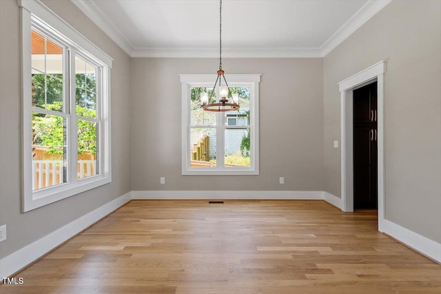 3934 Old Chapel Hill Rd, Durham, NC 27707 - unfurnished dining area featuring crown molding, light wood-style floors, and a chandelier