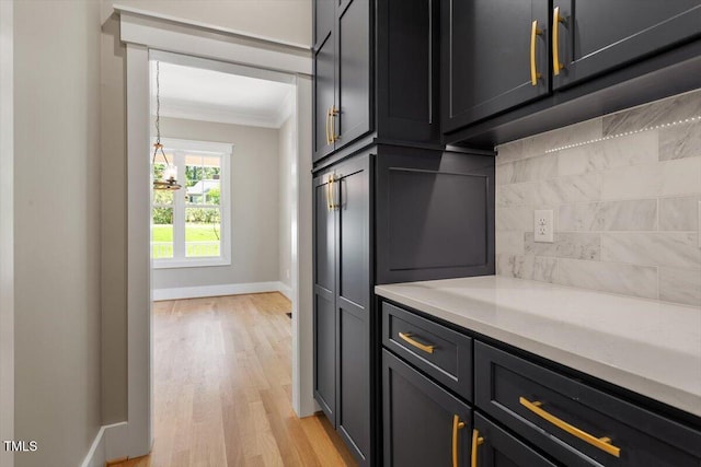 3934 Old Chapel Hill Rd, Durham, NC 27707 - kitchen featuring crown molding, light wood-type flooring, and tasteful backsplash