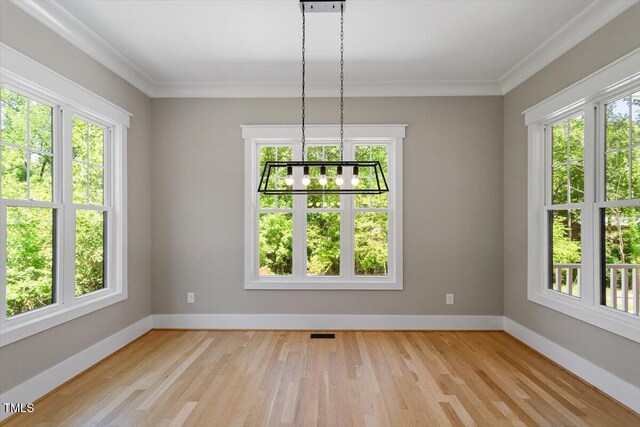 3934 Old Chapel Hill Rd, Durham, NC 27707 - unfurnished dining area featuring plenty of natural light, wood finished floors, a chandelier, and crown molding