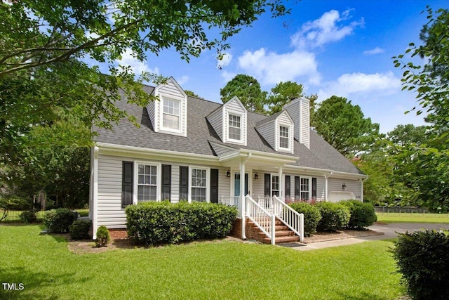 204 Paul Pl, Goldsboro, NC 27534 - cape cod-style house featuring a front yard, an attached garage, roof with shingles, and driveway