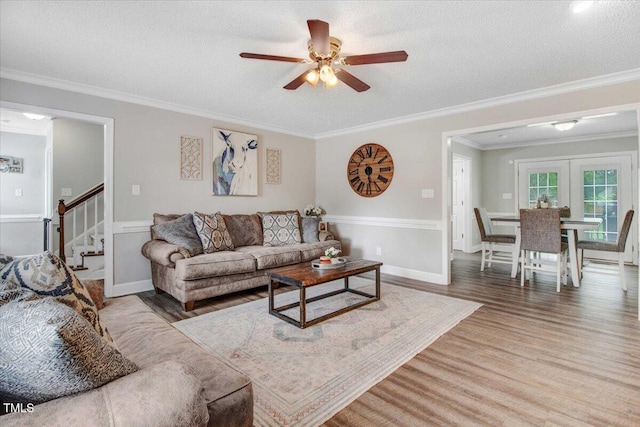 204 Paul Pl, Goldsboro, NC 27534 - living area featuring wood finished floors, ceiling fan, stairs, ornamental molding, and french doors