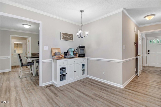 204 Paul Pl, Goldsboro, NC 27534 - dining room featuring light wood finished floors, a chandelier, a textured ceiling, crown molding, and plenty of natural light