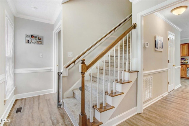 204 Paul Pl, Goldsboro, NC 27534 - stairs featuring crown molding and wood finished floors