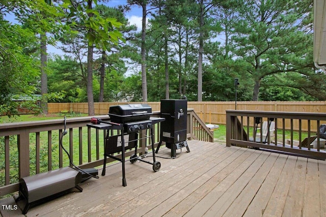 204 Paul Pl, Goldsboro, NC 27534 - deck with a fenced backyard, a grill, and view of scattered trees