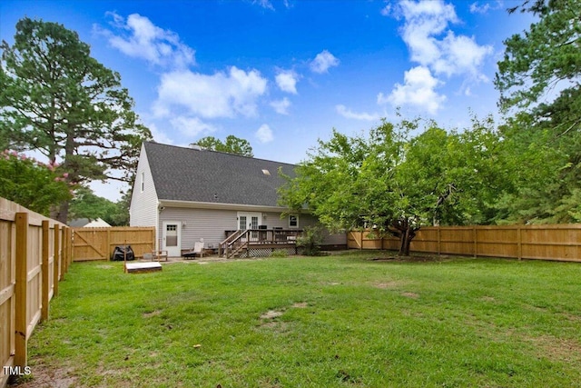 204 Paul Pl, Goldsboro, NC 27534 - back of property with a deck, a fenced backyard, and a shingled roof