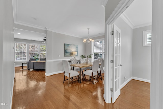 413 Westfalen Dr, Cary, NC 27519 - dining room featuring wood finished floors, a chandelier, and ornamental molding