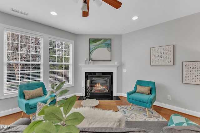 413 Westfalen Dr, Cary, NC 27519 - living area with ceiling fan, a fireplace with flush hearth, wood finished floors, and recessed lighting