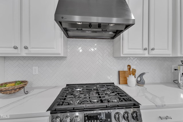 413 Westfalen Dr, Cary, NC 27519 - kitchen featuring ventilation hood, stainless steel range with gas stovetop, backsplash, white cabinetry, and light stone counters