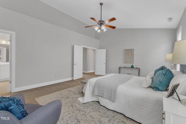 413 Westfalen Dr, Cary, NC 27519 - carpeted bedroom featuring high vaulted ceiling, connected bathroom, and a ceiling fan