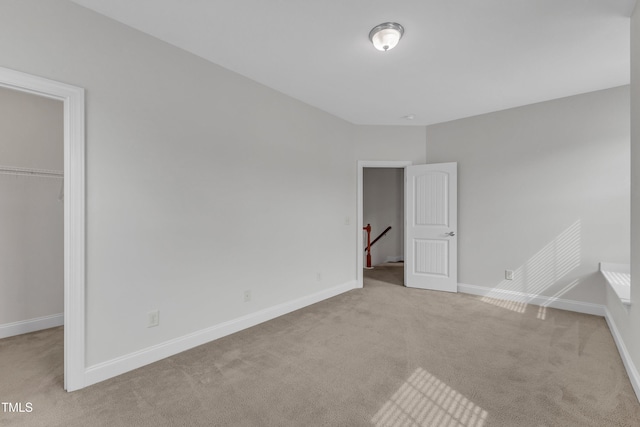 413 Westfalen Dr, Cary, NC 27519 - unfurnished bedroom with carpet floors, a spacious closet, and a closet