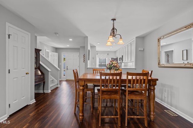 1815 Crystal Downs Ln, Raleigh, NC 27604 - dining room with dark wood-style flooring, stairs, a chandelier, and recessed lighting