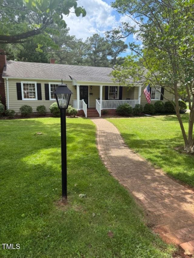 403 Rodwell St, Warrenton, NC 27589 - ranch-style home with covered porch, a chimney, and a front yard
