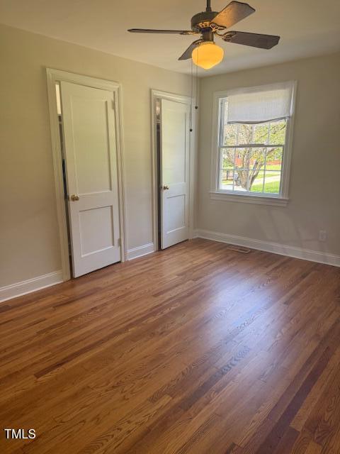 403 Rodwell St, Warrenton, NC 27589 - unfurnished bedroom with wood finished floors and ceiling fan