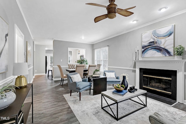 1821 Kelly Glen Dr, Apex, NC 27502 - living room with wood finished floors, ceiling fan, ornamental molding, a glass covered fireplace, and recessed lighting