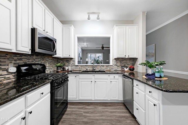 1821 Kelly Glen Dr, Apex, NC 27502 - kitchen with appliances with stainless steel finishes, ceiling fan, backsplash, white cabinetry, and wood finished floors