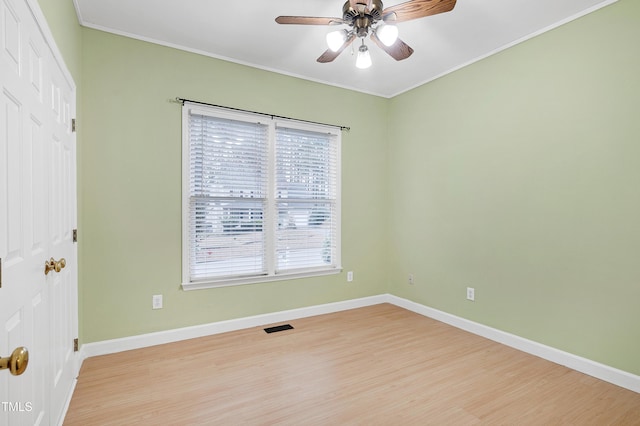 1821 Kelly Glen Dr, Apex, NC 27502 - empty room featuring light wood finished floors, plenty of natural light, ornamental molding, and ceiling fan