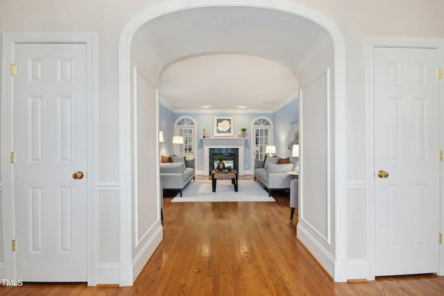 5204 Winter Holly Ct, Raleigh, NC 27606 - hall with arched walkways, wood finished floors, and ornamental molding