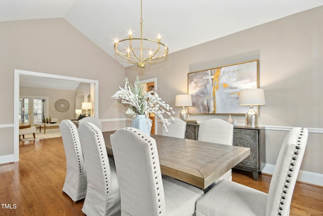 5204 Winter Holly Ct, Raleigh, NC 27606 - dining area with a chandelier, lofted ceiling, and wood finished floors