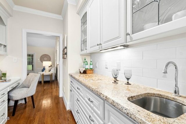 5204 Winter Holly Ct, Raleigh, NC 27606 - kitchen with crown molding, white cabinetry, tasteful backsplash, and glass insert cabinets