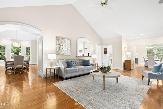 5204 Winter Holly Ct, Raleigh, NC 27606 - living room featuring arched walkways, wood finished floors, a ceiling fan, high vaulted ceiling, and recessed lighting