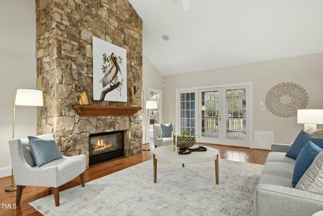 5204 Winter Holly Ct, Raleigh, NC 27606 - living area featuring wood finished floors, a fireplace, and high vaulted ceiling