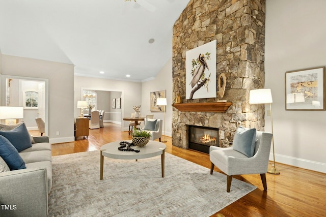 5204 Winter Holly Ct, Raleigh, NC 27606 - living area featuring a stone fireplace, wood finished floors, and vaulted ceiling