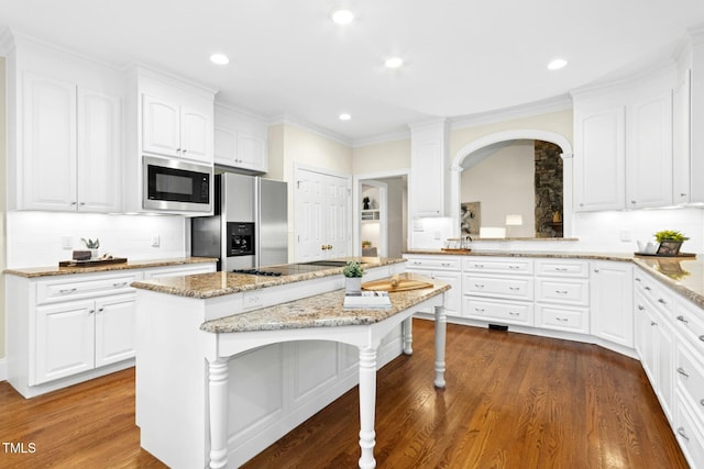 5204 Winter Holly Ct, Raleigh, NC 27606 - kitchen with built in microwave, stainless steel fridge, a kitchen island, recessed lighting, and backsplash