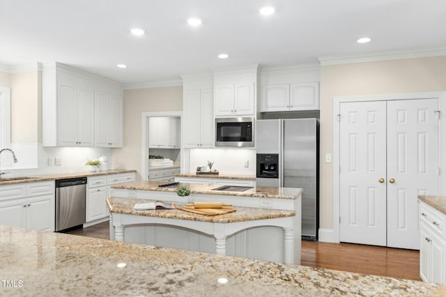 5204 Winter Holly Ct, Raleigh, NC 27606 - kitchen with stainless steel appliances, dark wood-style flooring, white cabinetry, tasteful backsplash, and light stone counters