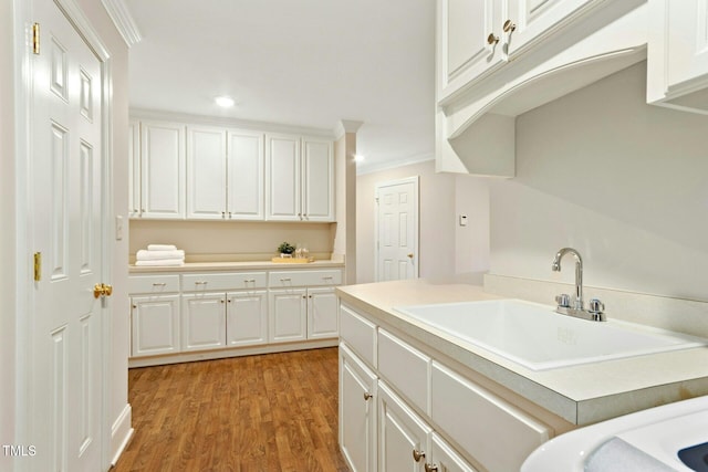 5204 Winter Holly Ct, Raleigh, NC 27606 - laundry room featuring crown molding, light wood-style floors, and recessed lighting