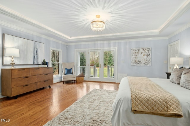5204 Winter Holly Ct, Raleigh, NC 27606 - bedroom featuring a raised ceiling, wood finished floors, access to outside, a chandelier, and ornamental molding